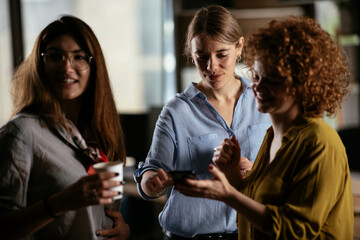 Colleagues in office talking and having fun. Friends working together..