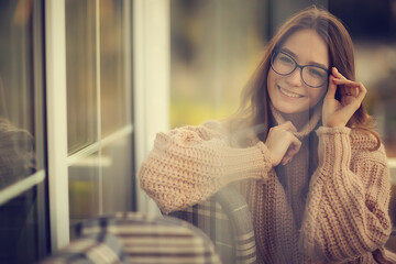 Fototapeta premium happy girl autumn cafe sweater concept vision model with glasses posing