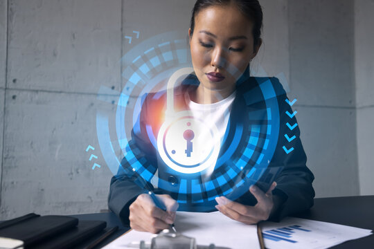 Businesswoman taking notes and lock drawing hologram. Double exposure. Education technology security solution concept.
