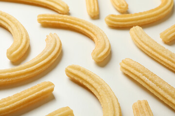 Tasty sweet churros on white background, close up
