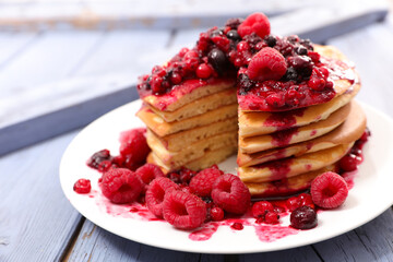 pancake pile with berry fruit syrup
