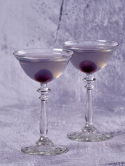 Aviation: a purple-bluish cocktail made with gin, maraschino, crème de violette and a dash of lemon juice, served with a maraschino cherry
