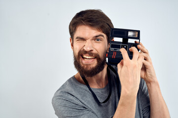 Fototapeta premium male photographer holding camera professional lens creative studio work light background