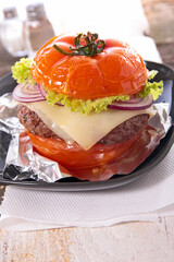 baked tomato burger with beef, cheese and lettuce