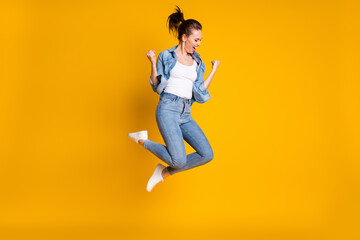 Fototapeta na wymiar Full length body size view of her she attractive lovely slim fit glad cheerful cheery girl jumping rejoicing having fun attainment isolated bright vivid shine vibrant yellow color background