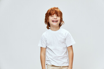 Cheerful red-haired boy Wide smile white T-shirt cropped 