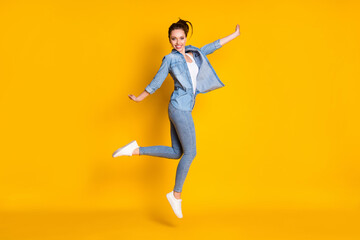 Fototapeta na wymiar Full body photo of charming cute content girl jump raise hands enjoy free spring time wear good look outfit sneakers isolated over vibrant color background