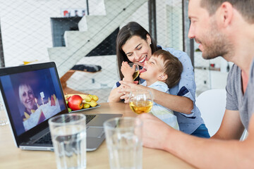 Happy child with parents in video chat on birthday