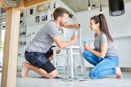 Young handyman couple working on chair