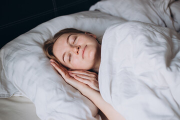 Beautiful young sexy woman sleeping in a white bedroom, morning time