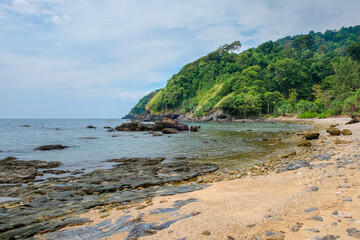 Beautiful sea tropical landscape. Rocky coast and sandy beach. Green hills covered with rainforest. Koh Lanta, Thailand
