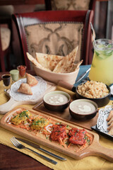 Having tandoori chicken and fish, friend rice, samosa and naan bread in Indian restaurant