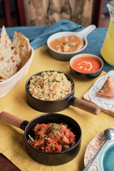 Having tandoori chicken and fish, friend rice, samosa and naan bread in Indian restaurant