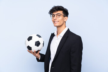 Argentinian Soccer coach over isolated blue background smiling a lot