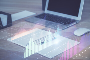 Financial graph colorful drawing and table with computer on background. Multi exposure. Concept of international markets.