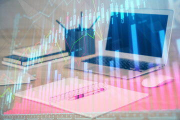 Stock market graph and table with computer background. Multi exposure. Concept of financial analysis.