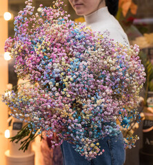 Close up of baby's breath flower (Gypsophila) bouquet. Woman holding big and beautiful mono bouquet...