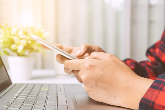 Close Up. Hands Woman Touching Smartphone On White Desk In Room. Woman Playing Social Network, Searching Job, Trading Stock At Home.