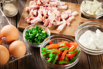 Ingredients for preparing omelette with bacon and vegetables