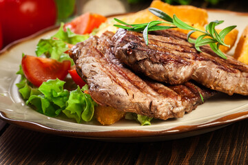 Succulent portions of grilled fillet mignon served with baked potatoes