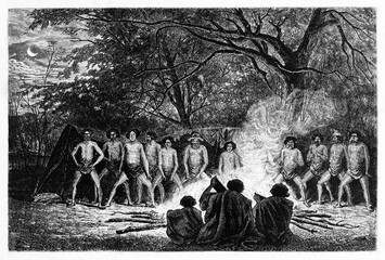 Australian aboriginals dance ritual around fire outdoor in the evening. Ancient grey tone etching style art by Riou and Gusmand, Le Tour du Monde, Paris, 1861 - 385228844