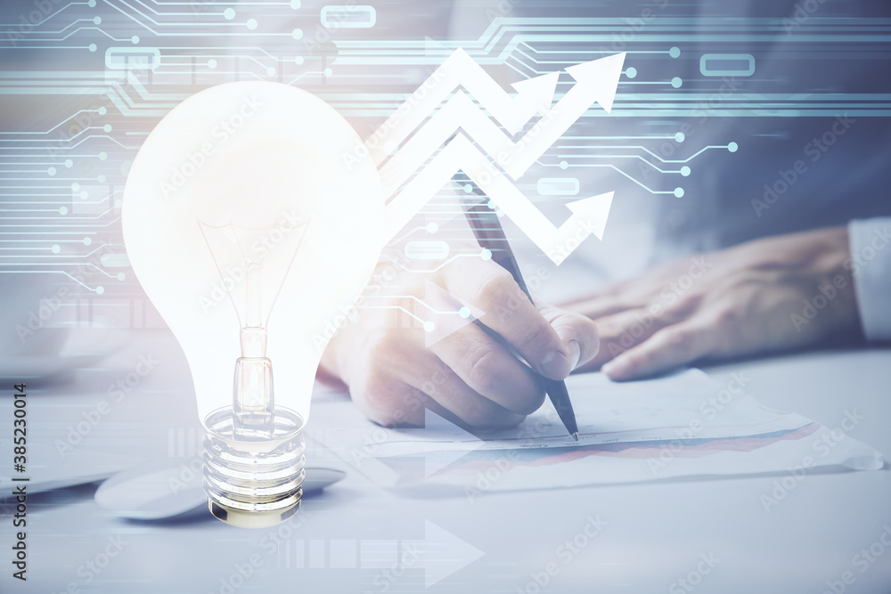 Poster view of bulb lamp idea concept icon on a futuristic interface with writing man's hand background. do