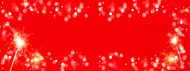 Silvester background panorama banner long - Firework sparklers and snowflakes on red texture with...