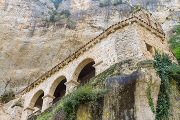 Fototapeta premium Tobera town romanesque singular church and waterfalls in Burgos province, Spain.