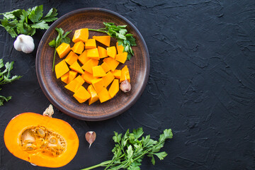 Beautifully chopped pumpkin salad, herbs, and ingredients for the dish. Creative atmospheric decoration