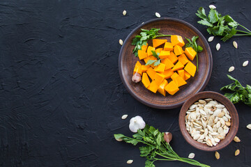 Beautifully chopped pumpkin salad, herbs, and ingredients for the dish. Creative atmospheric decoration