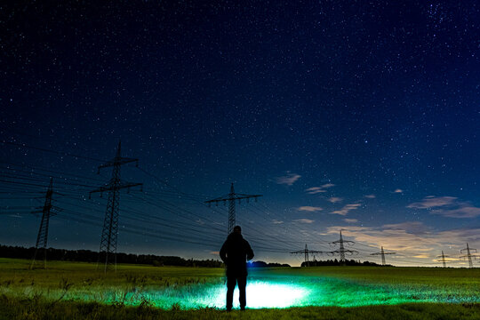 Starry Sky over a Guy with Flashlight in The Countryside
