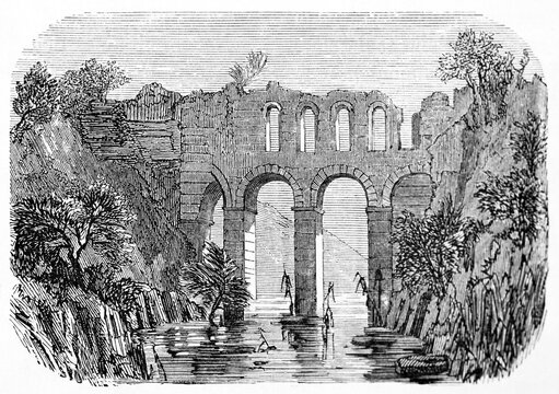 roman aqueduct ruins connecting two high rocky shores over small river. Lamos, Cilicia Trachaea, Turkey. Ancient grey tone etching style art by Grandsire, Le Tour du Monde, Paris, 1861
