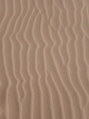 Fototapeta na wymiar Texture of sand with beautiful dunes