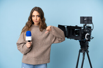 Reporter young woman holding a microphone and reporting news showing thumb down sign