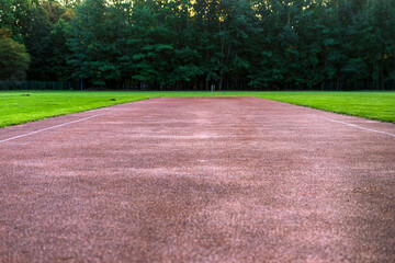 Red gravel sports track in the nature.