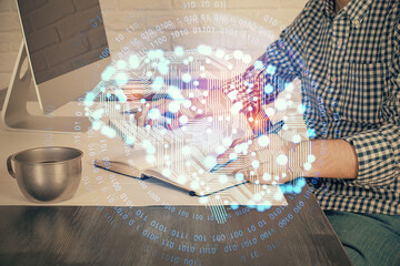 Man typing on keyboard background with brain hologram. Concept of big Data. Double exposure.