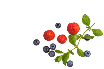 Fresh summer strawberries and blueberries with a mint branch isolated on a white background, top view. Flat layout. Space for text
