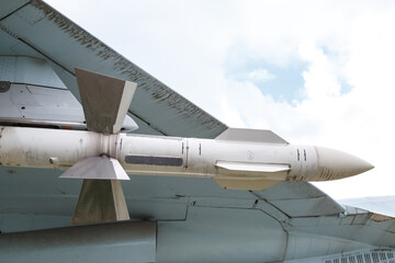 The air-to-air missile is suspended under the wing of the aircraft. Fragment of the plane