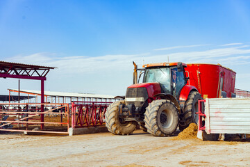 Modern red agricultural tractor in a farm