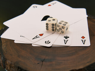 Ace playing cards with wite bone dice. Casino betting and gambling concept. Close up