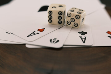 Fototapeta na wymiar Ace playing cards with wite bone dice. Casino betting and gambling concept. Close up