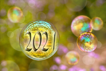 2021 soap bubble on green nature background, new year greeting card