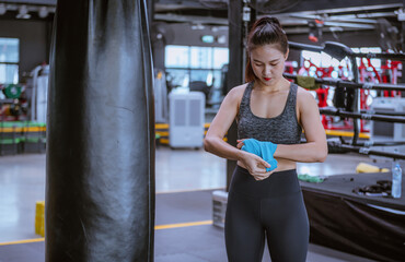 Portrait beauty sport woman wear sportwear posing under exercise with fighting fitness equipment at gym ,she exercise for strong ,make muscle ,protecting basic and good healthy..