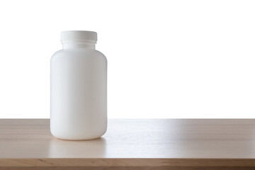 Medicine bottle on wood table isolated on white background
