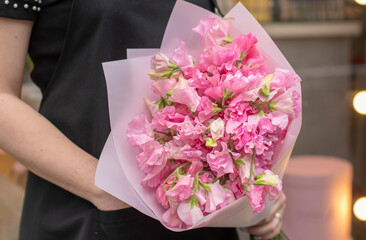Flower shop. Beautiful bouquet of mixed flowers in woman hand. the work of the florist at a flower...