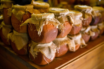 stylish clay jars with jam or honey
