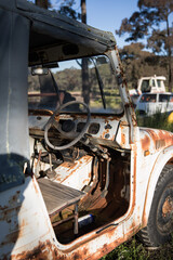 Old rusty car ute on a farm