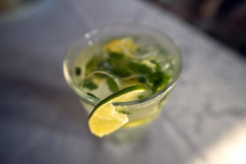 Mojito in a glass with lime and mint top view