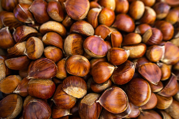 A lot of chestnuts in the shell poured into a box