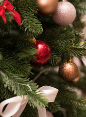 Christmas bouquet. Red flower of carnation, cone and cotton with Christmas tree branches. New year bouquet flowers and fir branches in a basket. Christmas wreath